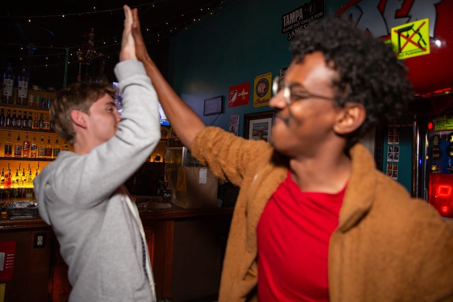 Two new friends high-fiving at a Joybreak meetup in Orlando